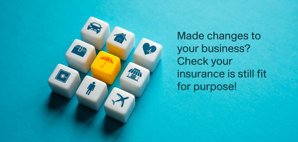 Eight cubes arranged in a square showing different symbols for different kinds of insurance (for instance, car and business insurance), with a coloured umberella symbolising protection in the middle of the square. Text reads "Made changes to your business? Check your insurance is still fit for purpose!"