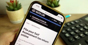 Mobile phone showing the www.gov.uk webpage about filing a self assessment tax return online