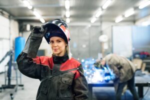 Female welder wearing protective clothing