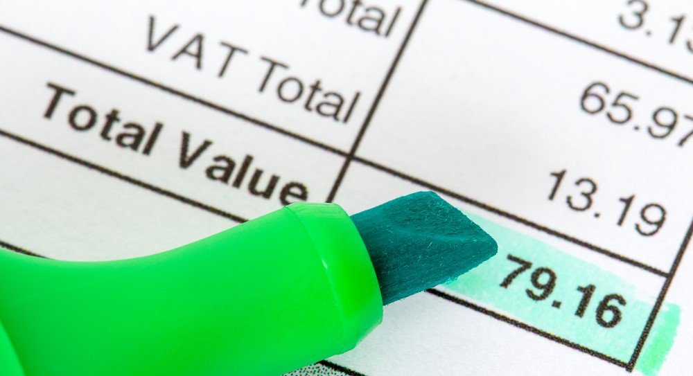 An invoice showing the VAT Total and Total Value, with a highlighter pen highlighting the amount of the Total Value